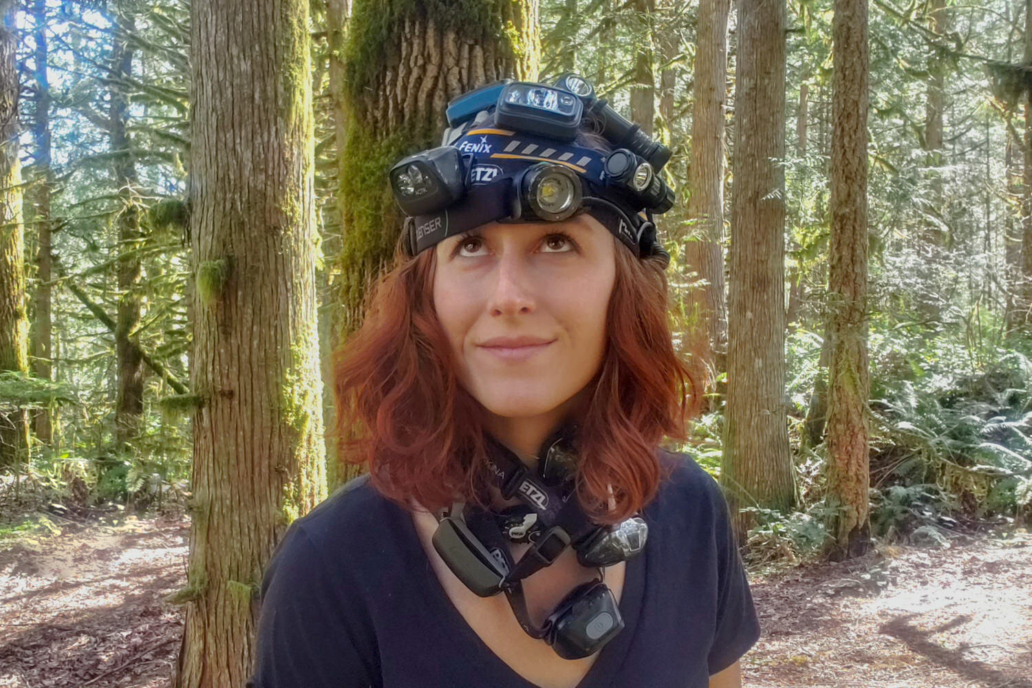A woman with a whole bunch of headlamps on her head