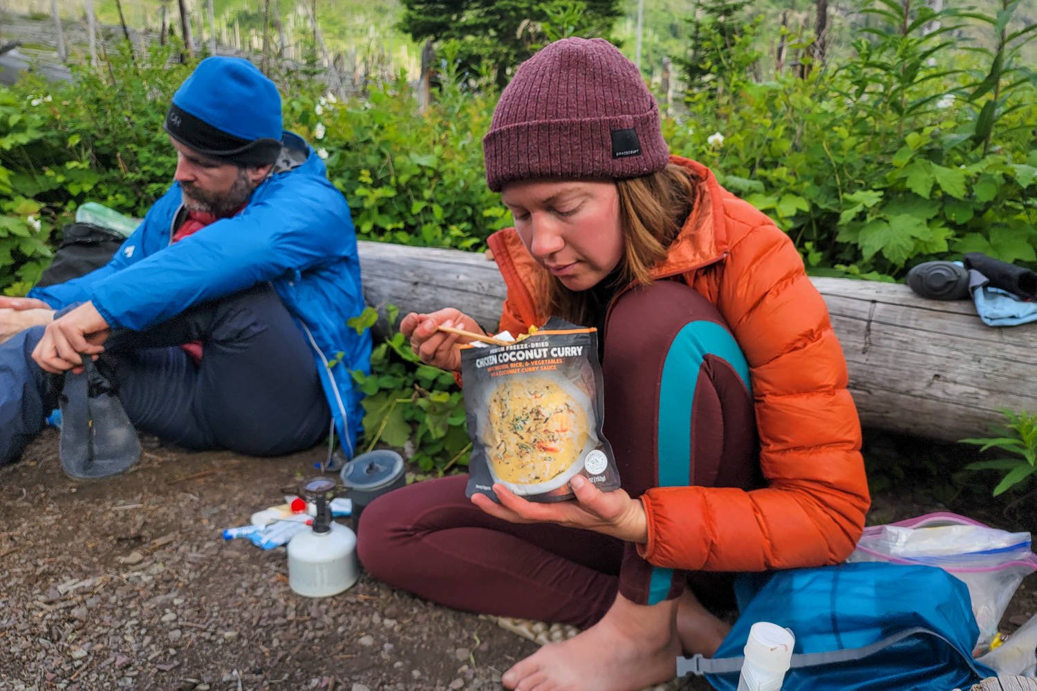 A+freeze+dried+meal+and+a+steaming+backpacking+stove+in+front+of+a+mountain