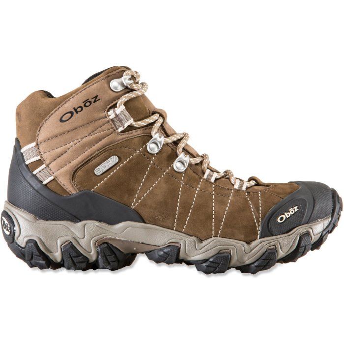 Brown hiking boots with black toe and heel, white laces, and silver hardware