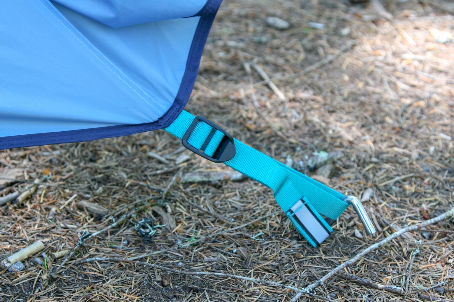 An REI Steel Hook Stake holding down a camping tent