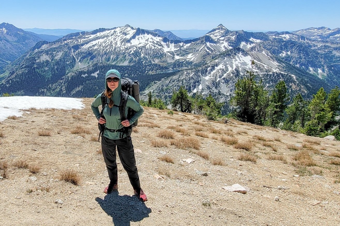 A backpacker wearing the Outdoor Research Echo Hoodie in the Wallowas