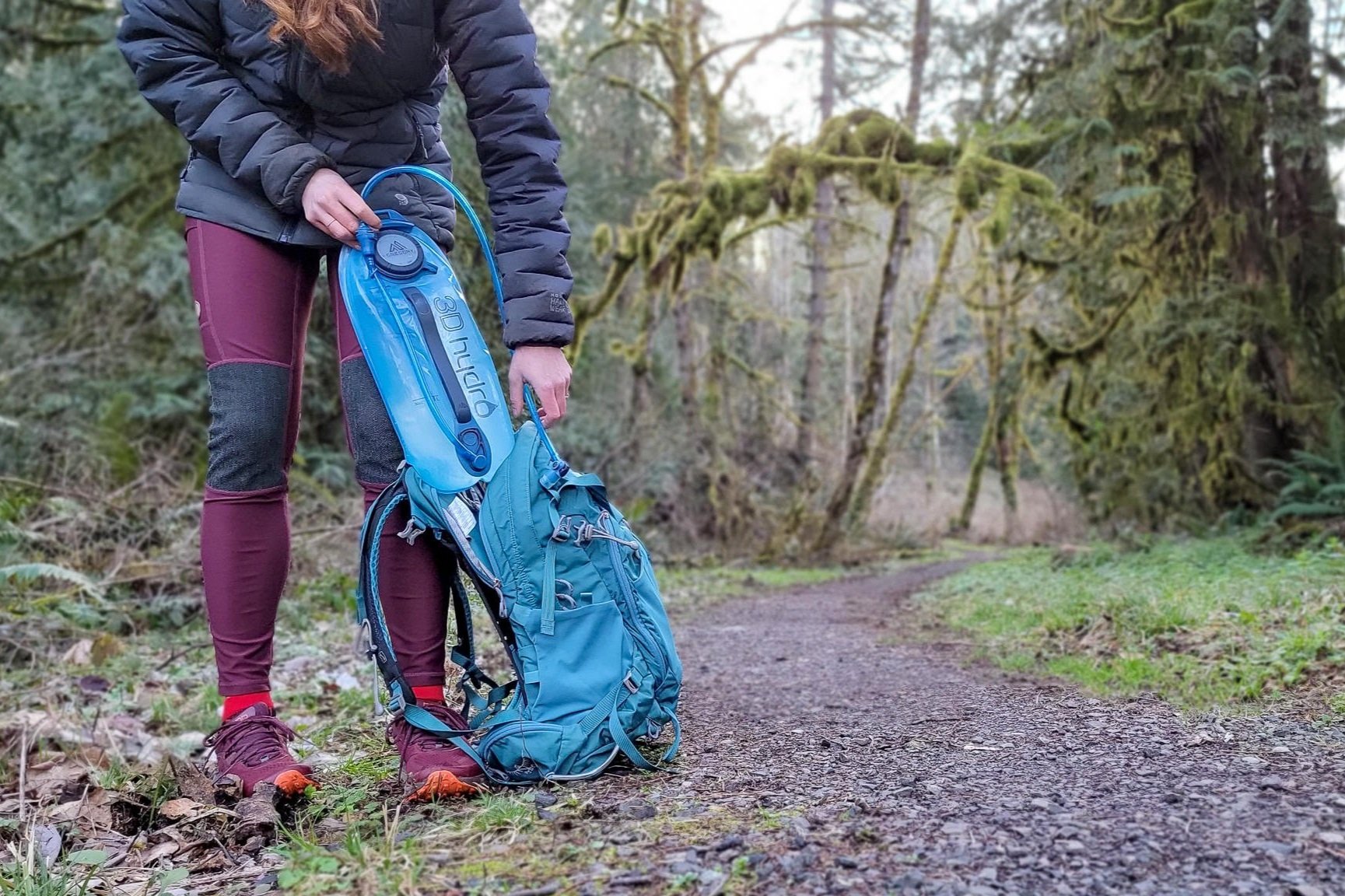 A hiker loading the Gregory 3D Hydro into a backpack
