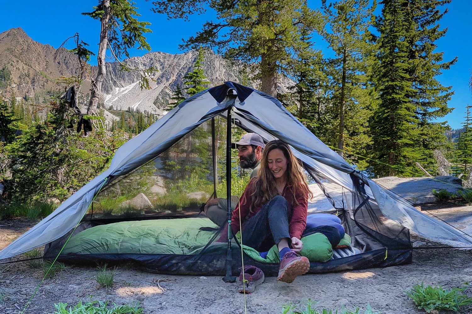 Two backpackers inside of the Six Moon Designs Lunar Duo Backpacking Tent
