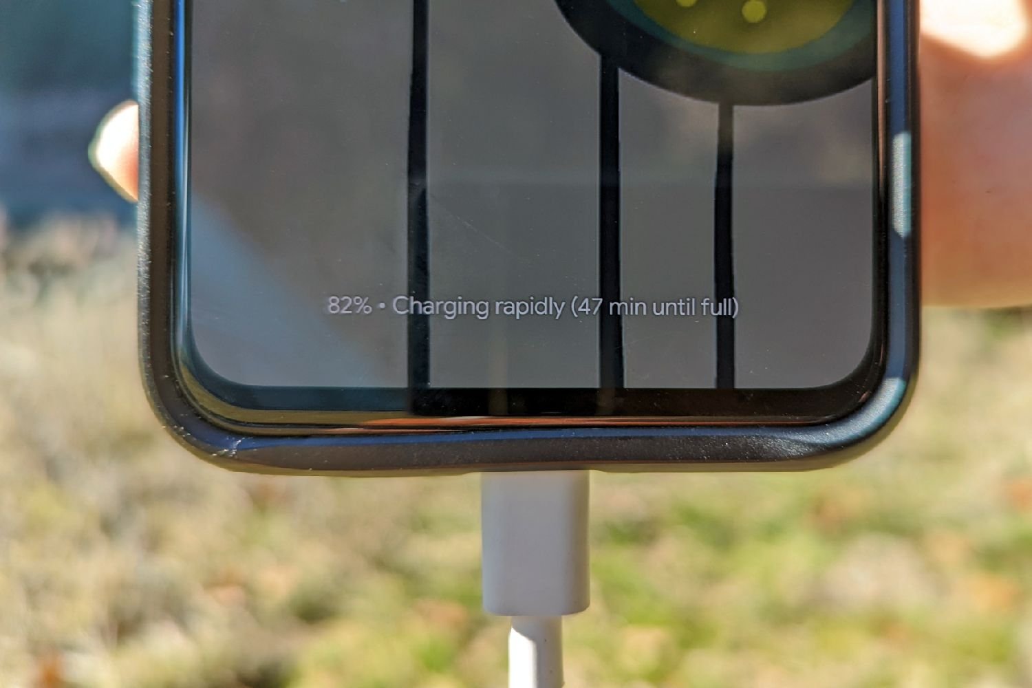 A close up of a cell phone screen showing that it is charging rapidly