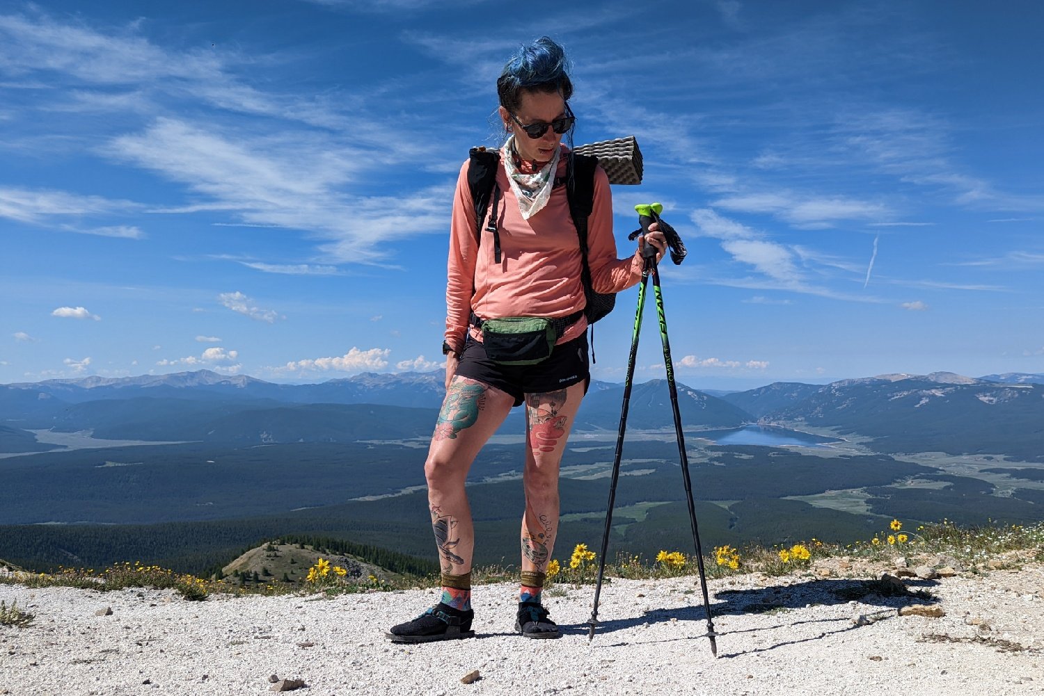 A hiker standing on a mountain pass wearing a LiteAF Featherweight Fanny Pack