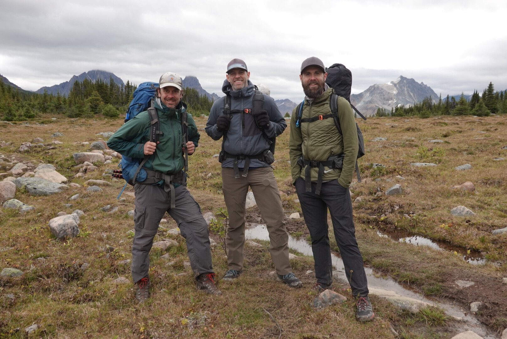 Three male backpackers wearing different hiking pants