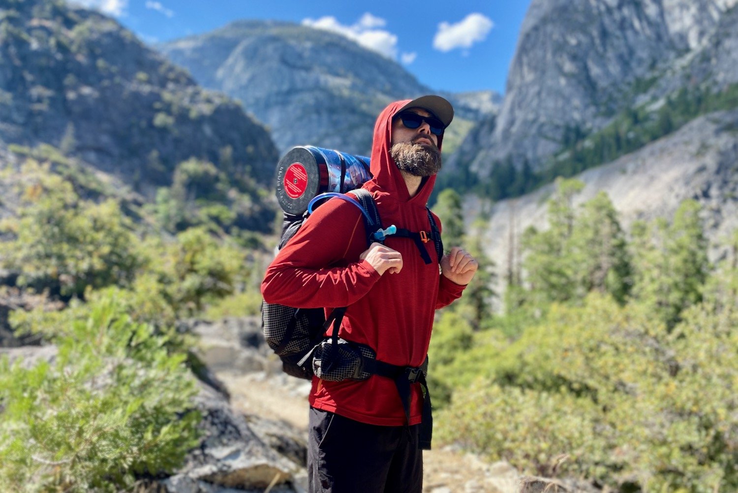 A backpacker wearing a red Prana Sol Defender sun shirt in Yosemite National Park